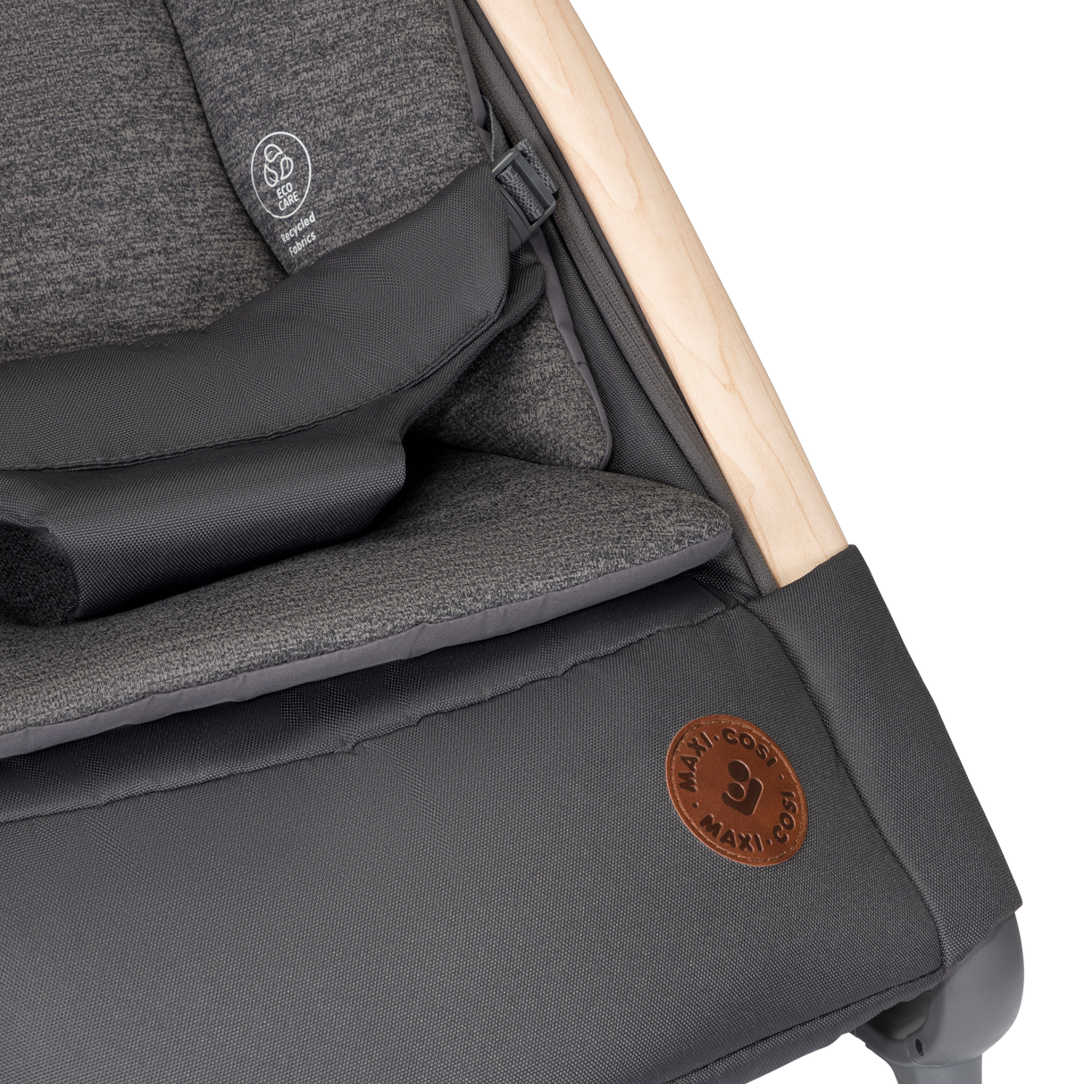 Close-up of a gray stroller with wooden handle and visible brand logo.