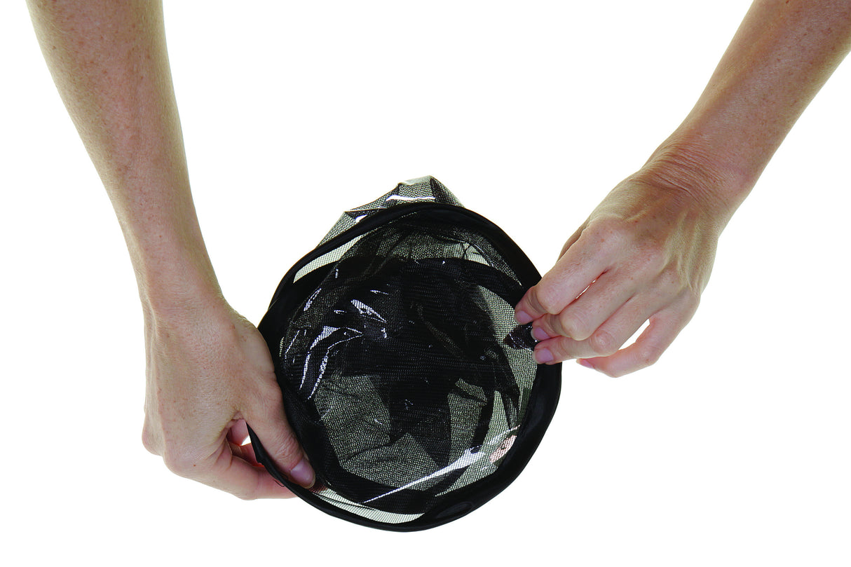 Person holding a black mesh car shade against a white background