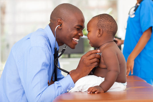 Doctor examining a child with a stethoscope in a medical setting