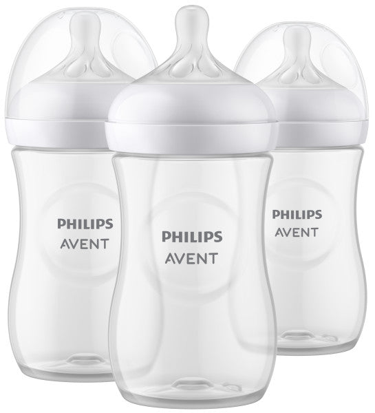 Three Philips Avent baby bottles with white caps on a white background