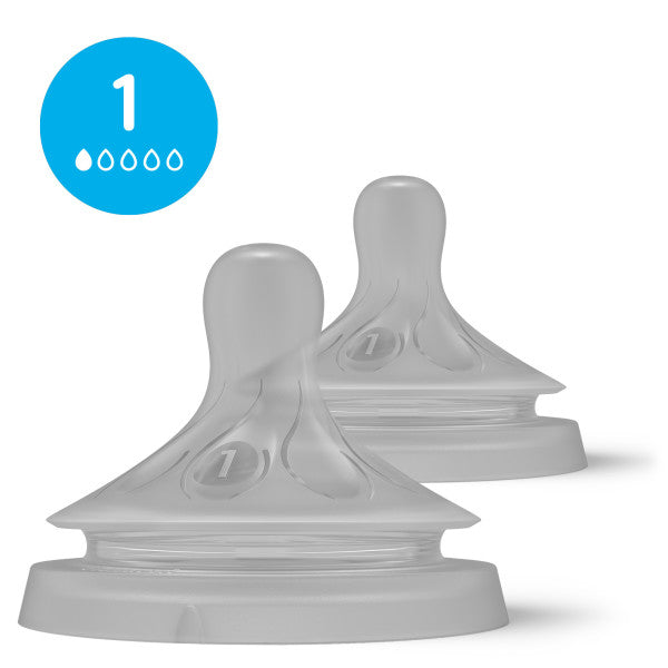 Two gray baby bottle nipples on a white background