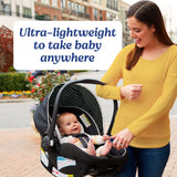 An image of a smiling woman caretaker in a yellow shirt holding a black Graco Snugride Lite XL Infant Car Seat with a baby inside the seat. Graphic text on the image reads "Ultra-lightweight to take baby anywhere." 