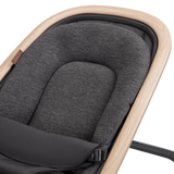 Gray cushioned seat in a baby bouncer with beige frame