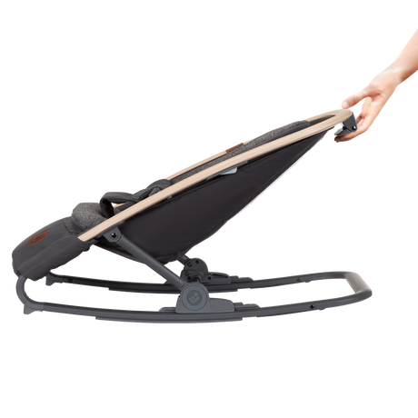 Black baby rocker with beige handle being held by a hand on a white background