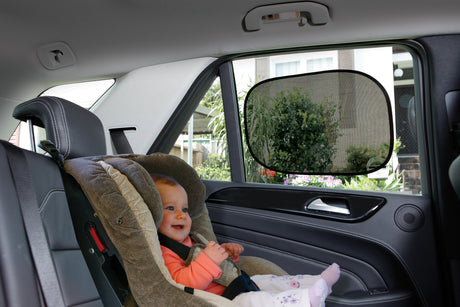 Child in a car seat with a rearview mirror in a vehicle