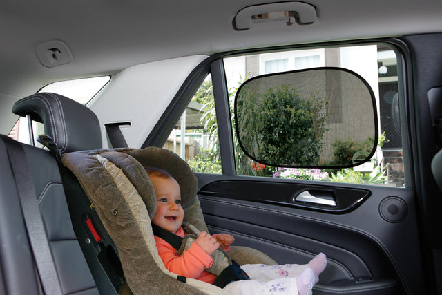 Child in a car seat with a rearview mirror in a vehicle