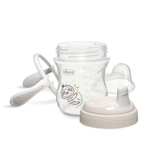 White baby bottle with accessories on a white background