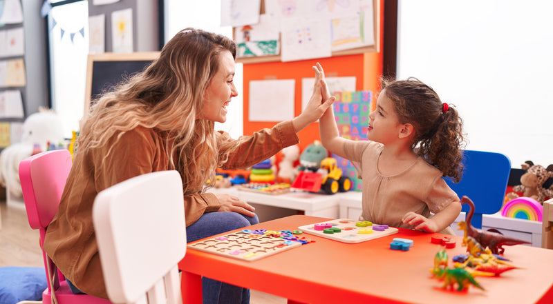 Teacher and student in a classroom with educational toys