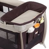 Baby bassinet with storage pockets and toys on a white background