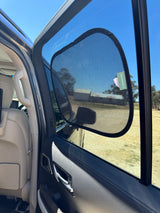 Car door open with car shade with a clear sky landscape.