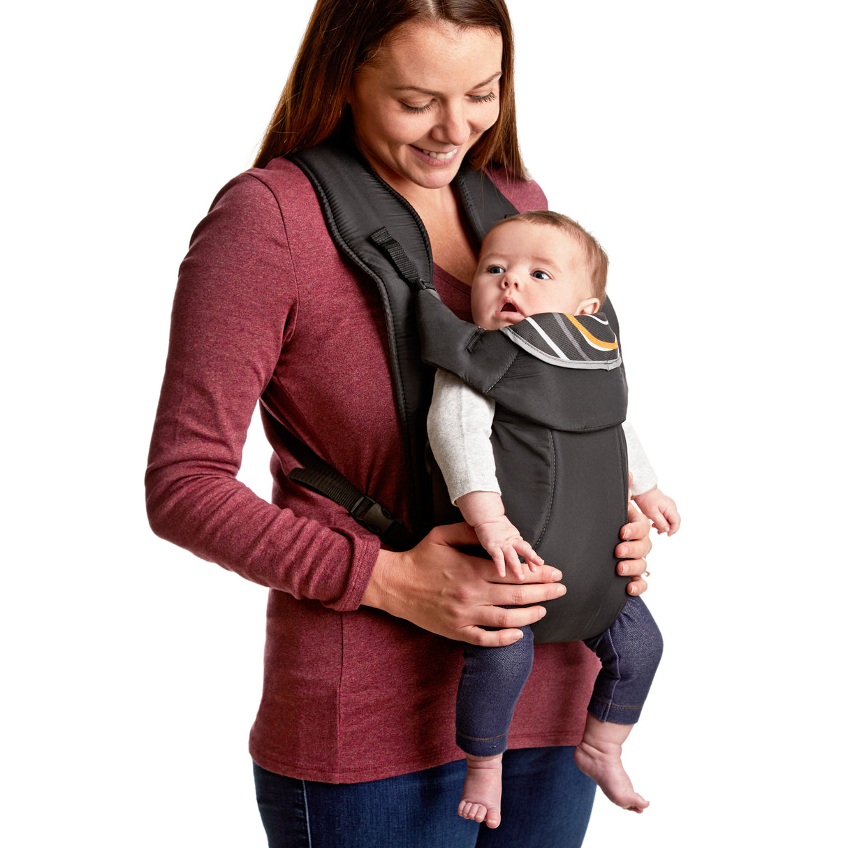 Woman holding a baby in a carrier against a white background