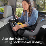 Woman installing a car seat with text 'Ace the install - SnugLock makes it easy!'