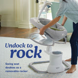 Baby swing seat with text 'Undock to rock' on a light-colored floor.