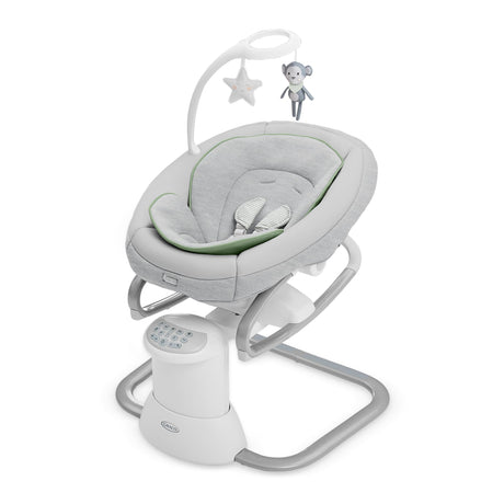 Baby swing with star and moon hanging toys on a white background