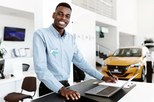 Man smiling and using a laptop.