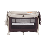 Portable baby crib with beige and black design on a white background