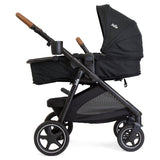 Black stroller with wooden handles on a white background