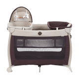 Portable baby crib with dark and beige color scheme on a white background