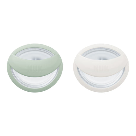 Two round containers with lids, one green and one white, on a white background.