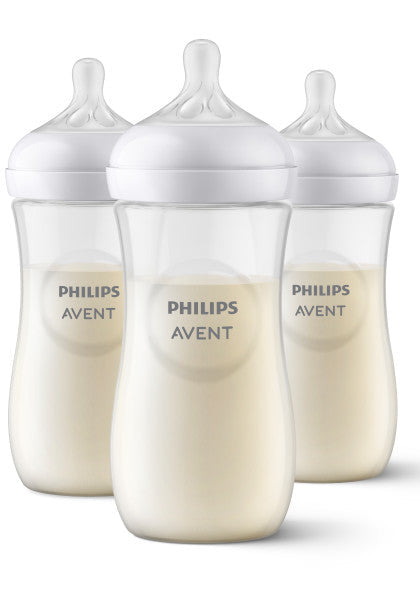 Three Philips Avent baby bottles with milk simulation on a white background