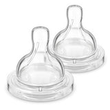 Two clear anti colic baby bottle nipples on a white background