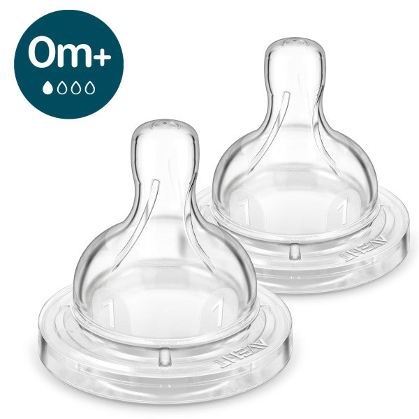 Two clear baby bottle anti colic nipples on a white background