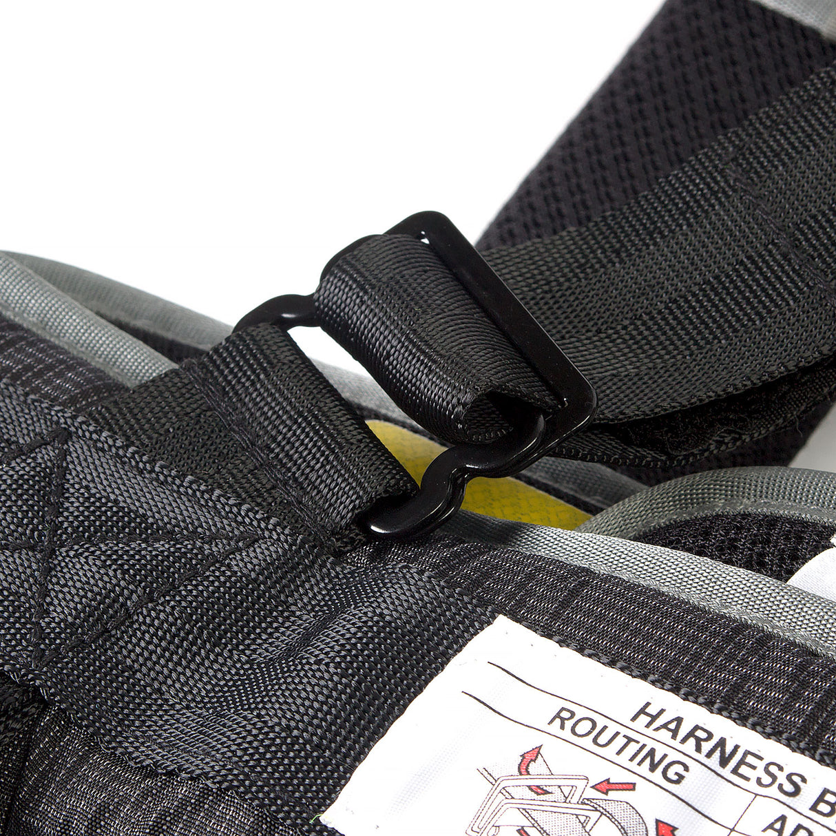 Close-up of a black harness with a label on a white background