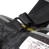 Close-up of a black harness with a label on a white background