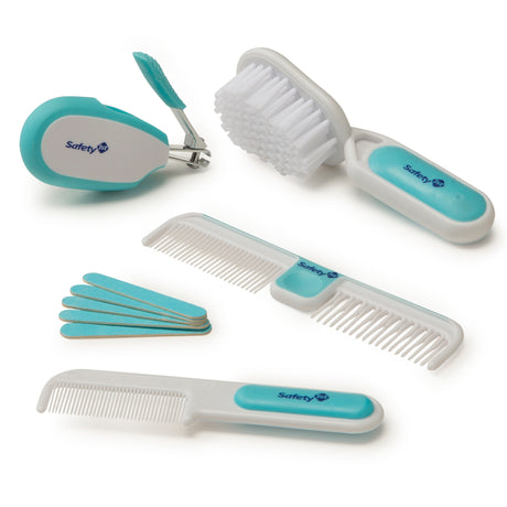 Set of baby grooming tools including a comb, brush, and nail clipper with Safety 1st branding on a white background.