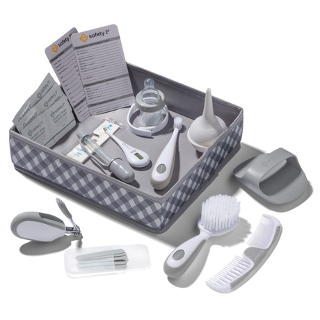 Baby care product set with various items in a checkered box on a white background