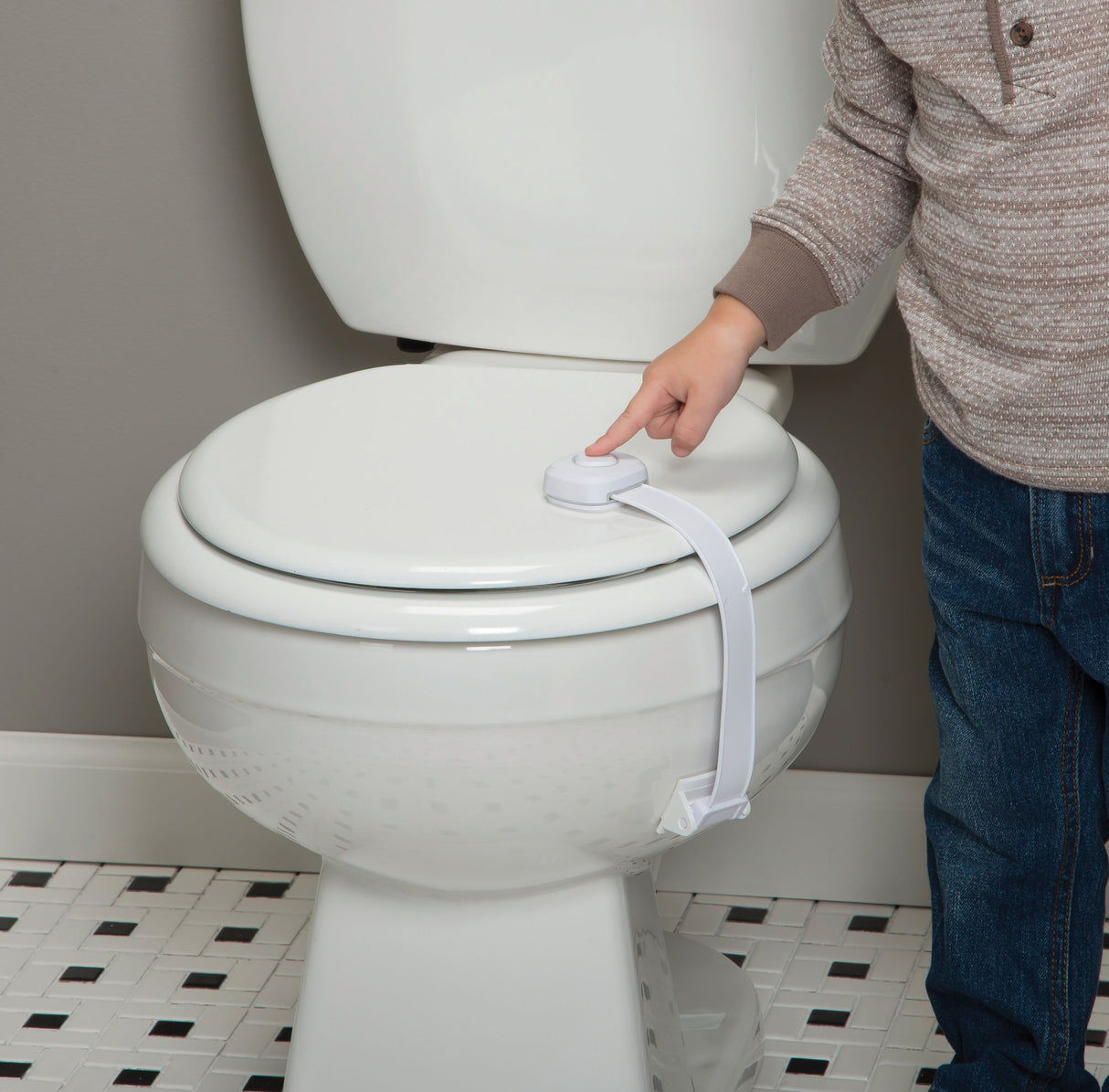 Person using a toilet seat cover attachment on a white toilet.