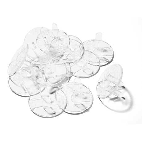 Clear plastic plug protectors on a white background